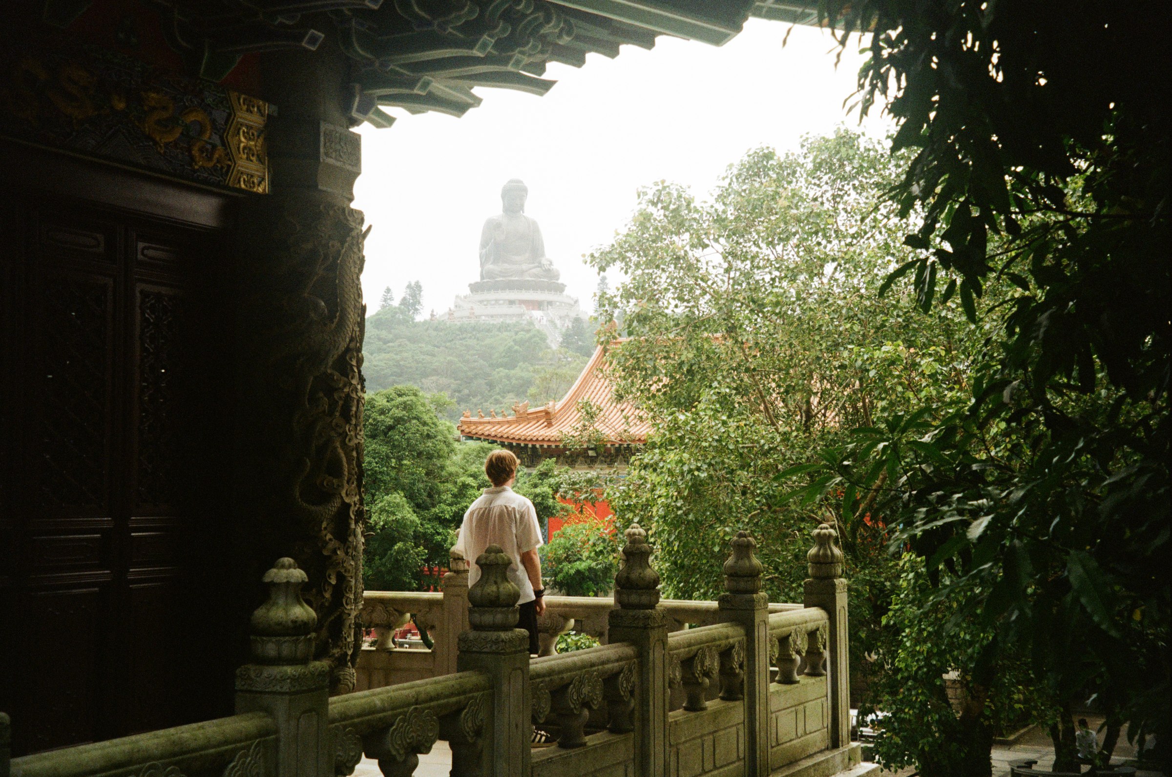 Tian Tan Buddha framed through a temple archway